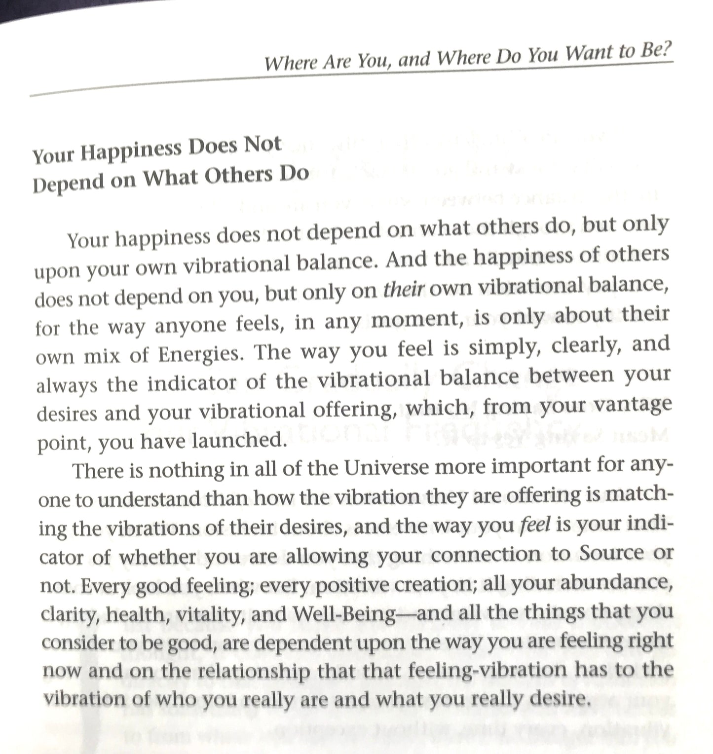 Text on a white background with motivational quote about happiness and personal vibration.
