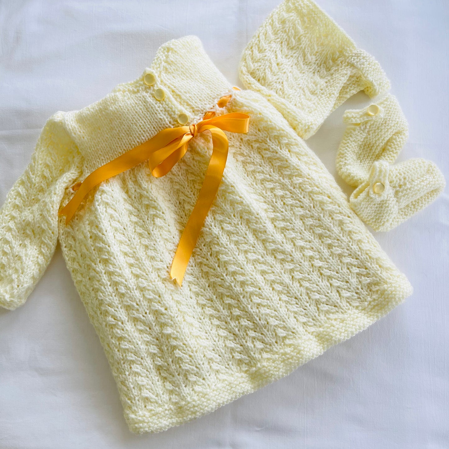 Flat lay - showing baby layette set - ‘Created by Lel’ - Local Artisan