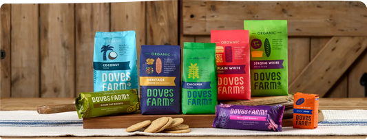 Doves Farm product range including Ascorbic Acid Vitamin C powder, displayed on a natural surface