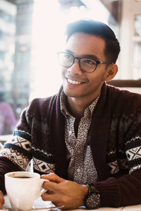Picture of Man Smiles Over Coffee In Cafe | Credit Samantha Hurley - shopify.com/stock-photos