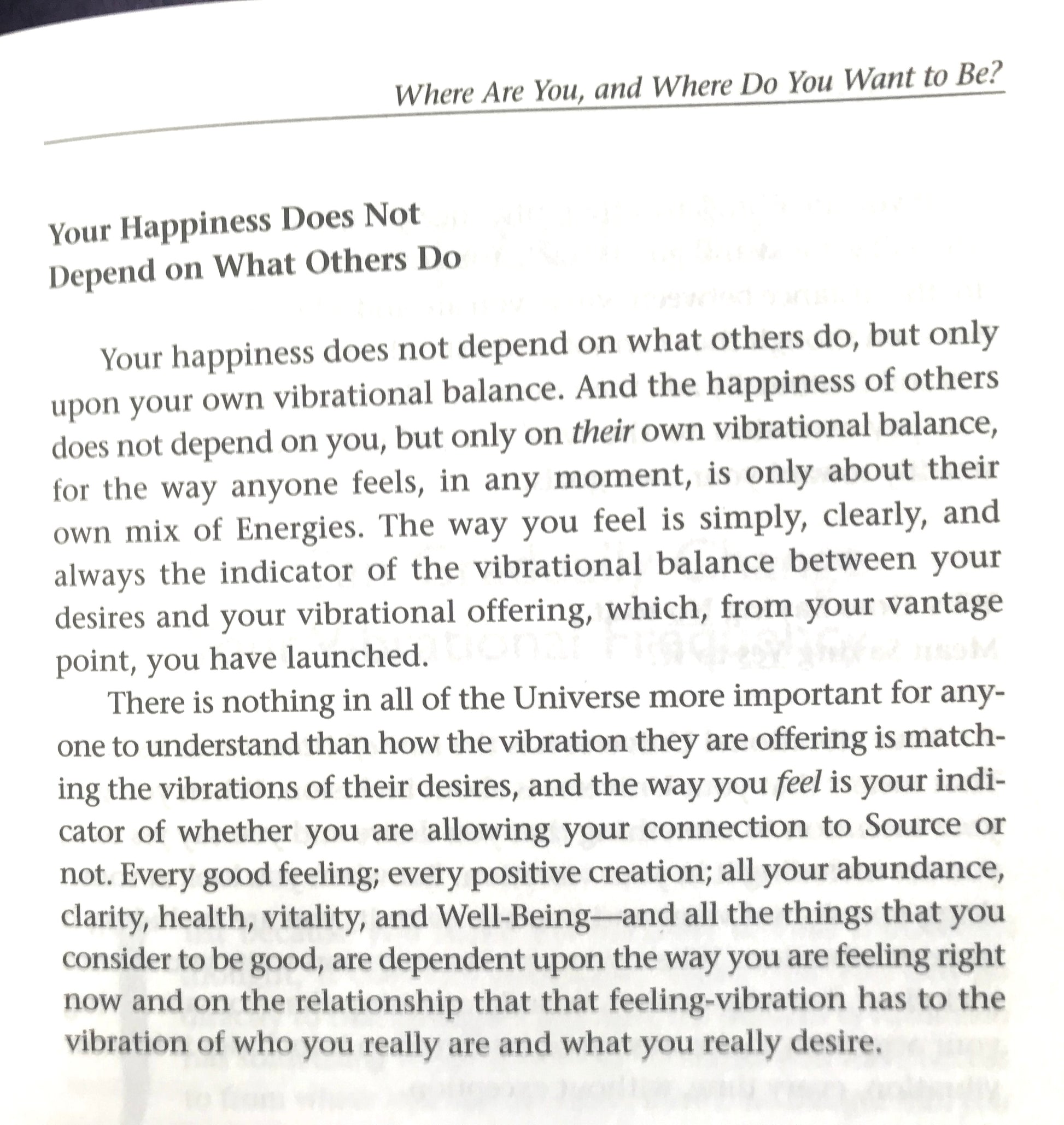 Text on a white background with motivational quote about happiness and personal vibration.