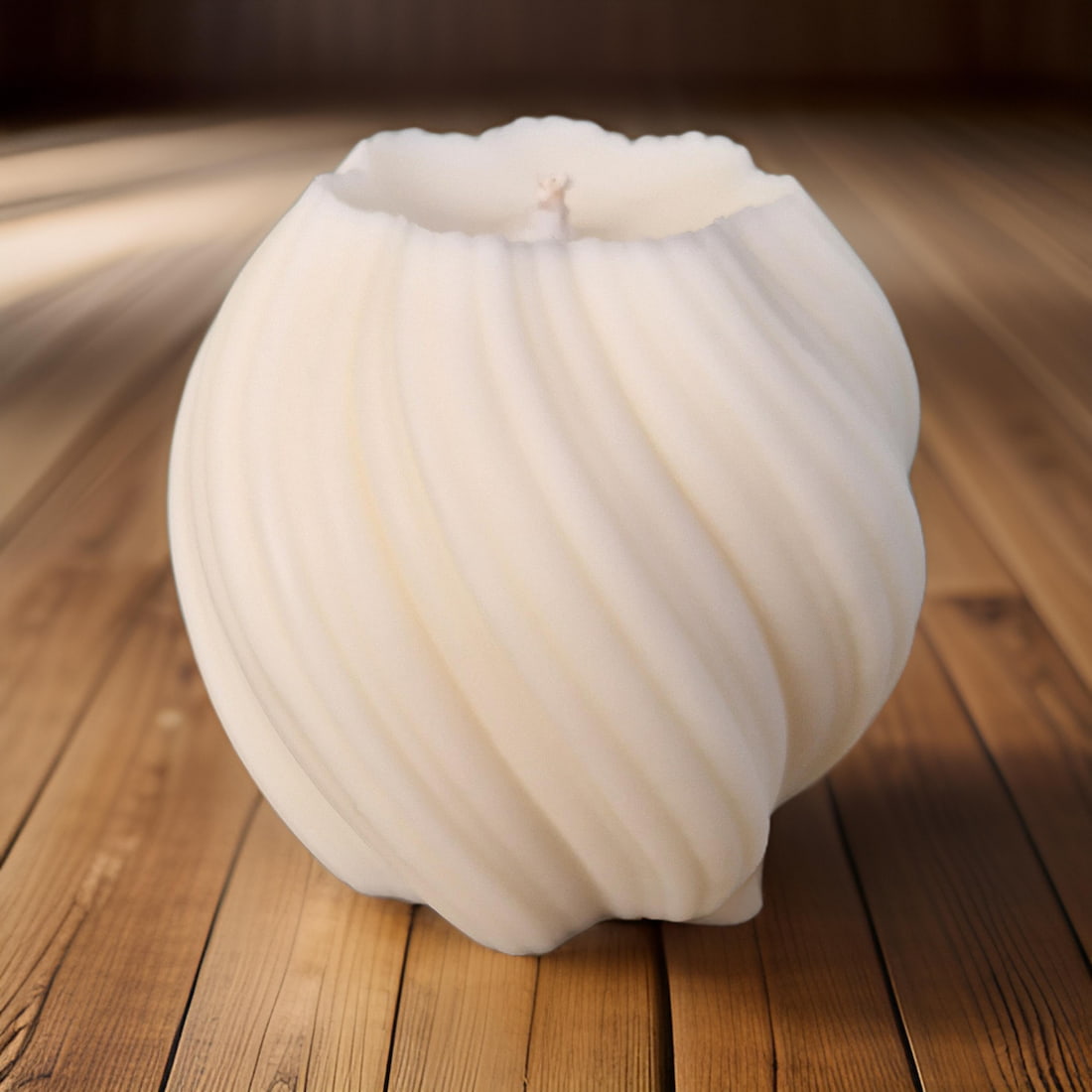 White swirl candle on a wooden surface