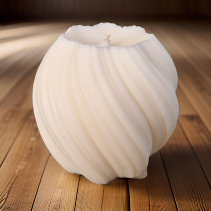 White swirl candle on a wooden surface