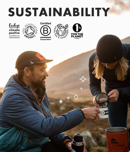 Two people outdoors drinking Exhale coffe