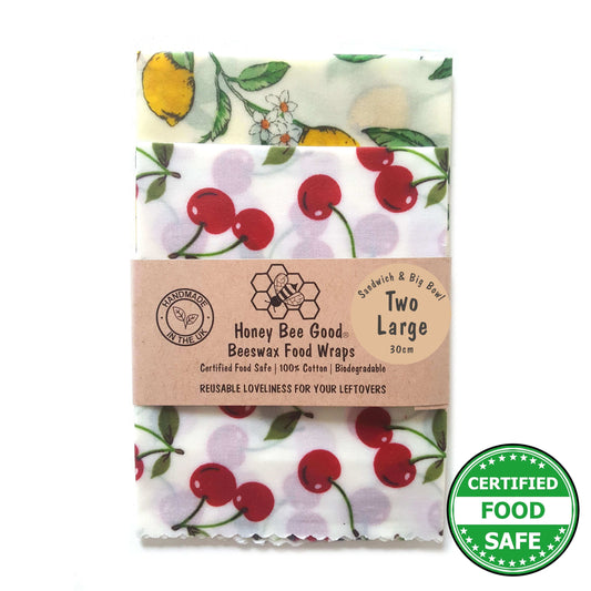 Pack of Honey Bee Good beeswax food wraps with cherry design on a white background