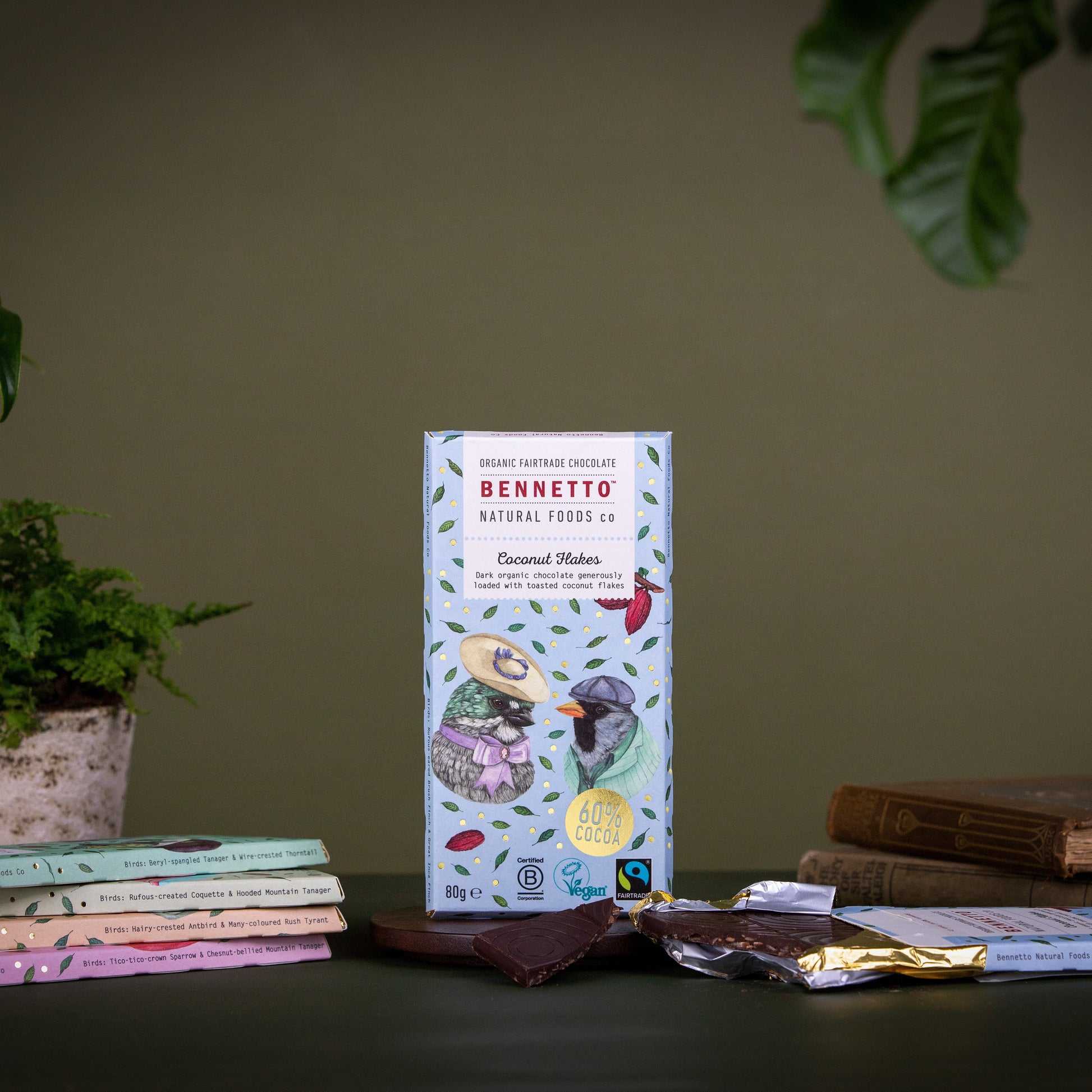 Bennetto coconut flakes packaging on a table with books and a plant in the background