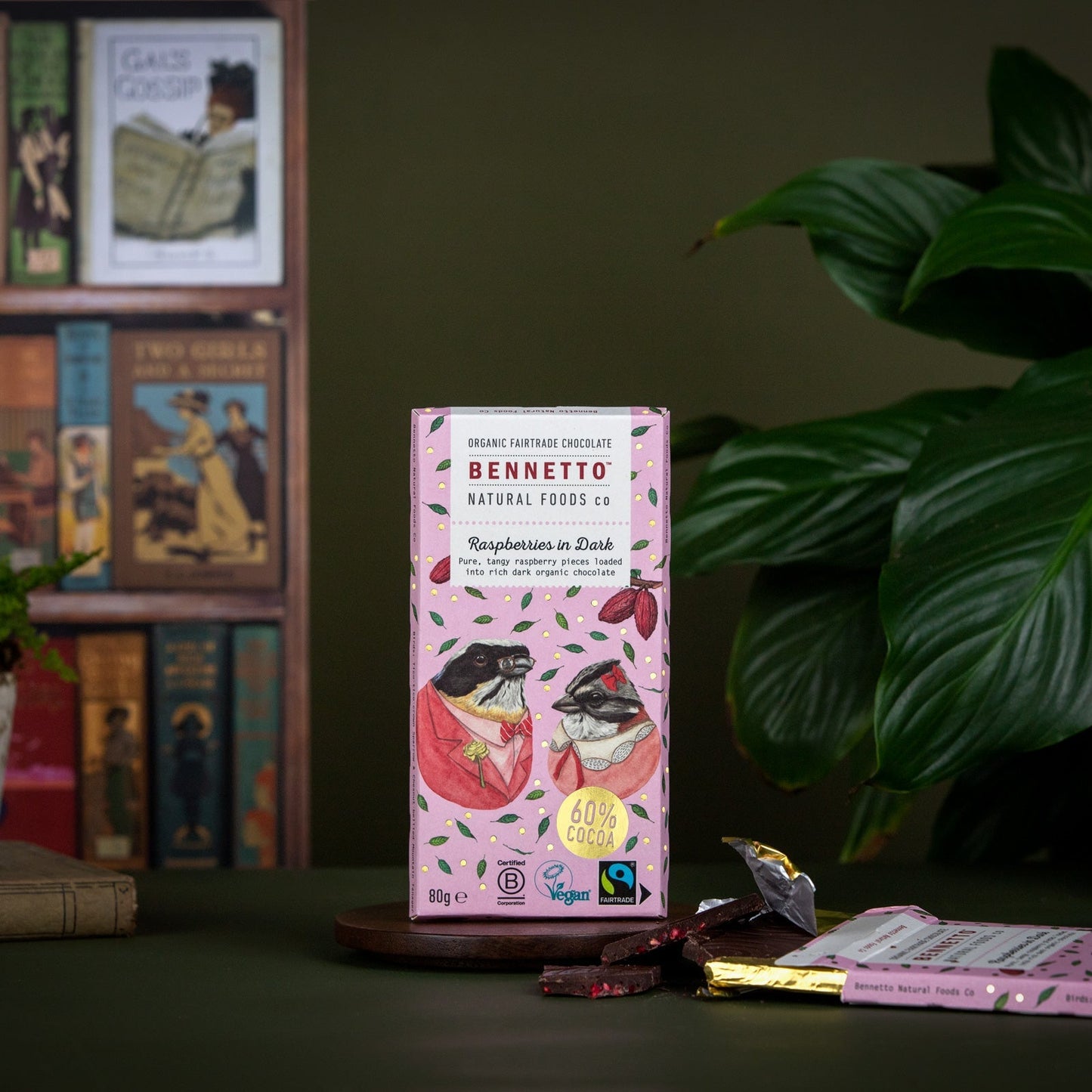 Bennetto chocolate packaging on a table with books and plants in the background