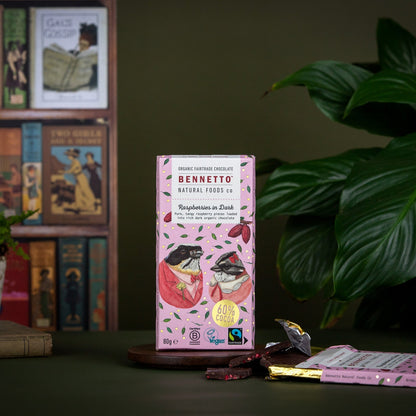 Bennetto chocolate packaging on a table with books and plants in the background